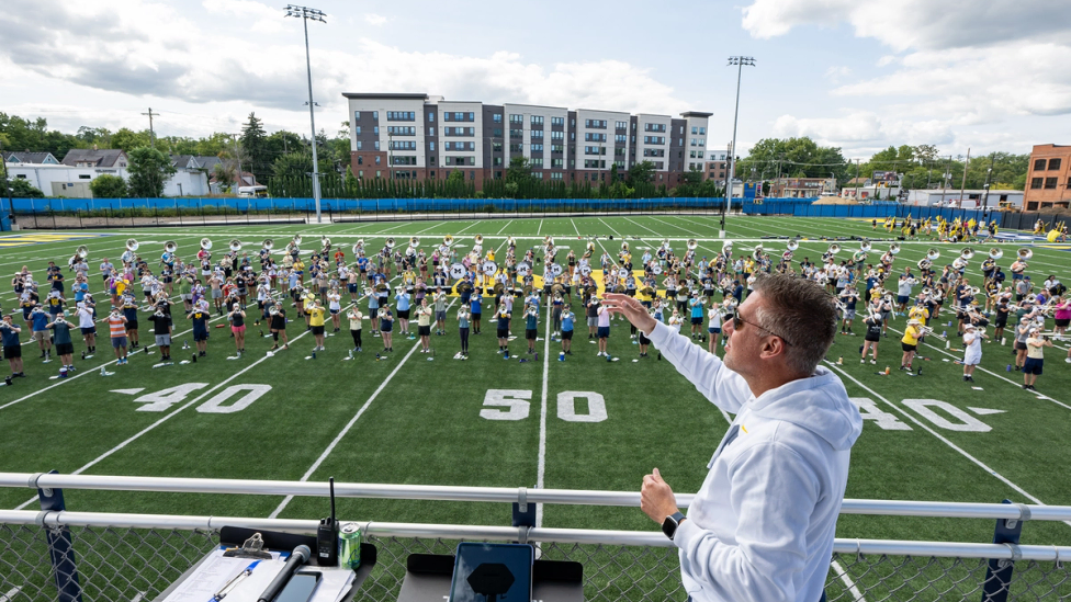 John Pasquale, Donald R. Shepherd Professor of Conducting and director of Michigan Marching and Athletic Bands, leads the band in a rehearsal at its new Elbel Field practice facility.