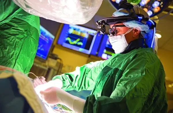 A surgeon performing surgery in an operating room