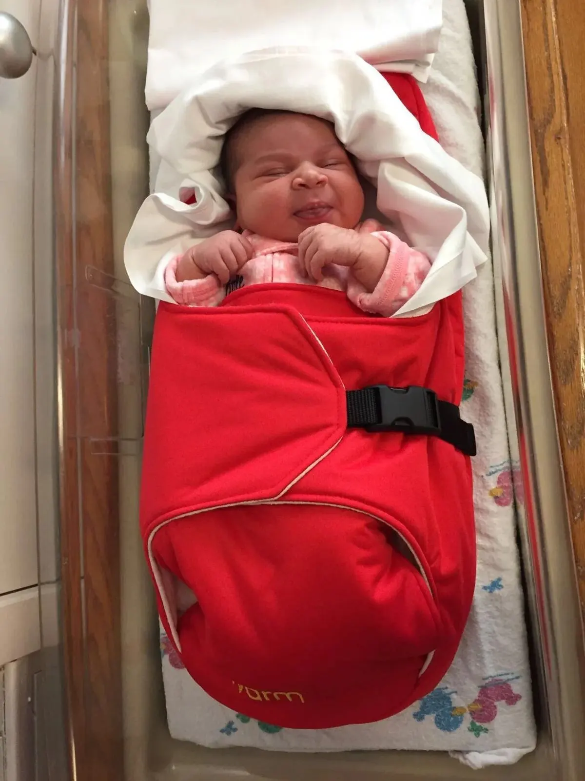 An infant wrapped in the Warmilu heating blanket