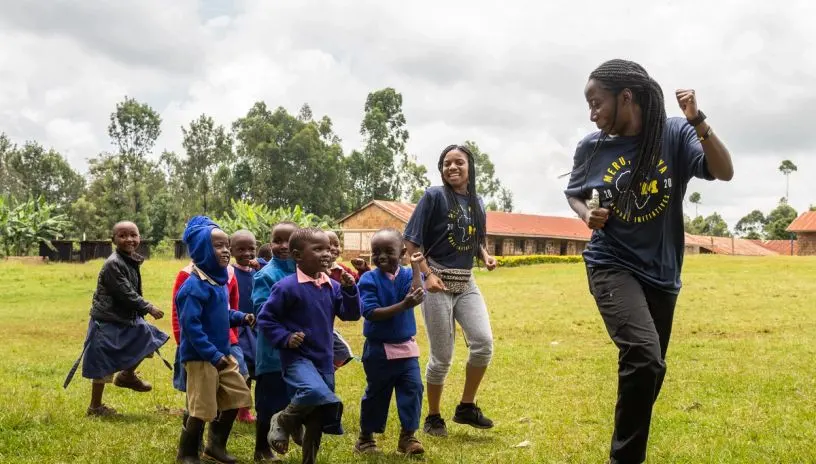 People leading a group of children on a study abroad assignment