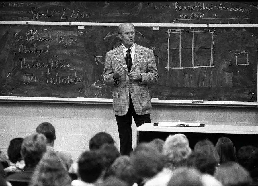 A black and white photo of President Gerald Ford teaching a class in a lecture hall