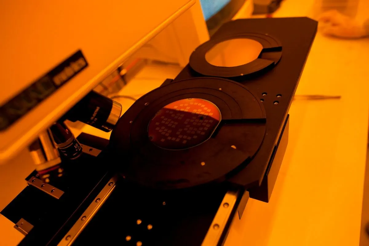 Silicon wafters next to a microscope lens