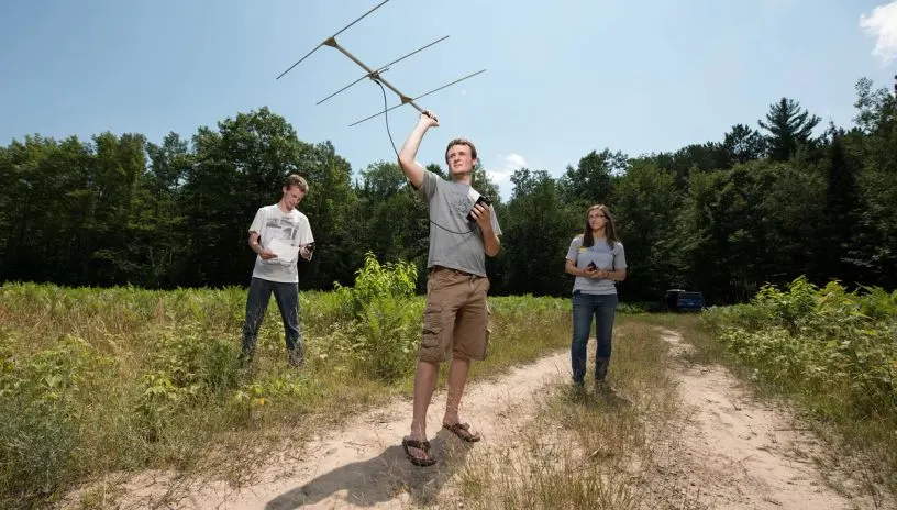 students in a field testing a device