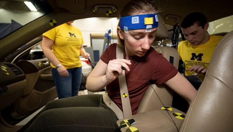 People hooking up equipment to test a car