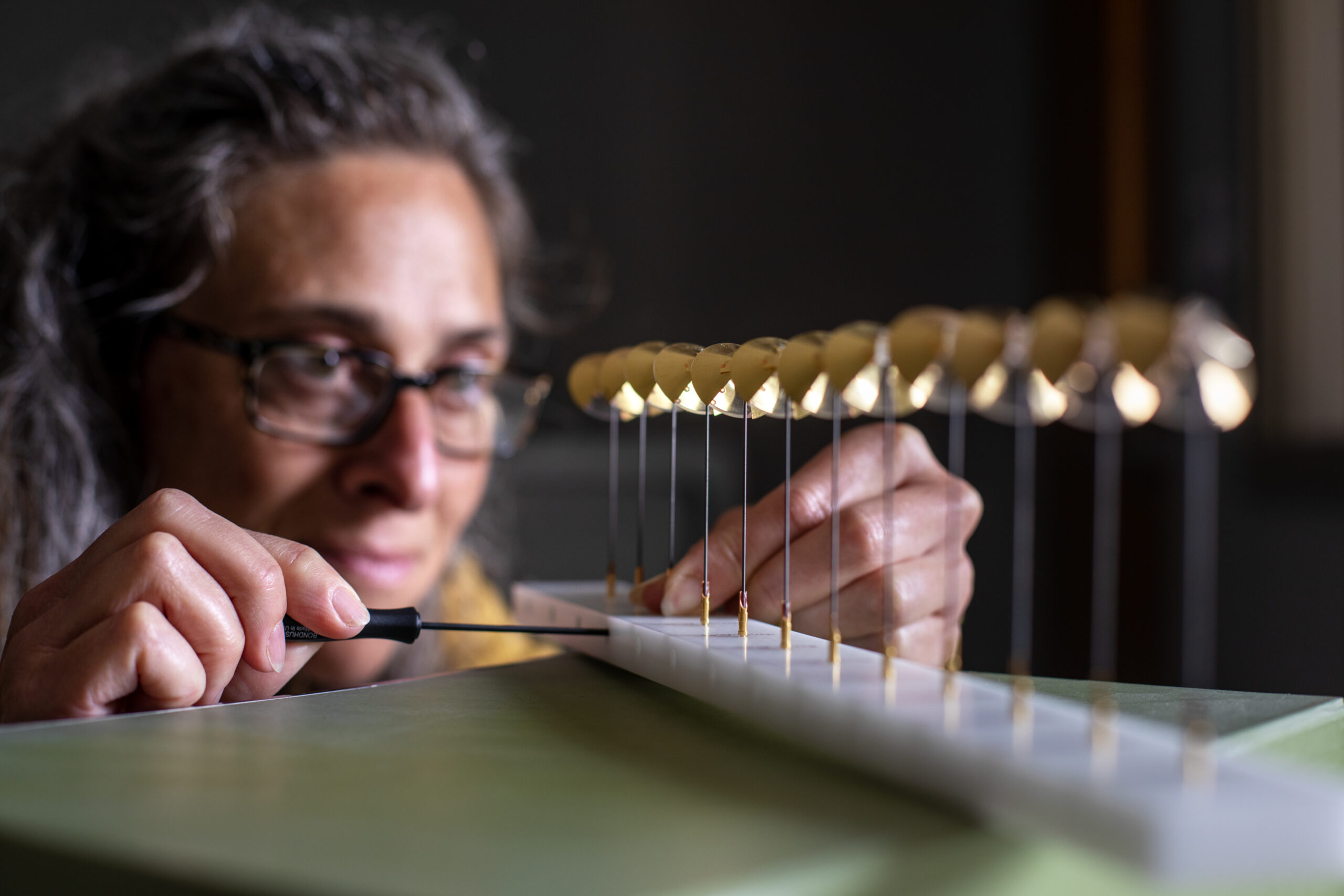 Professor places screwdriver into laser device