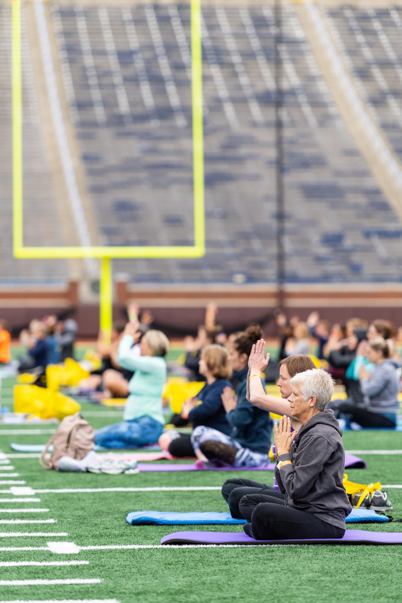 Yoga class on Michigan football field