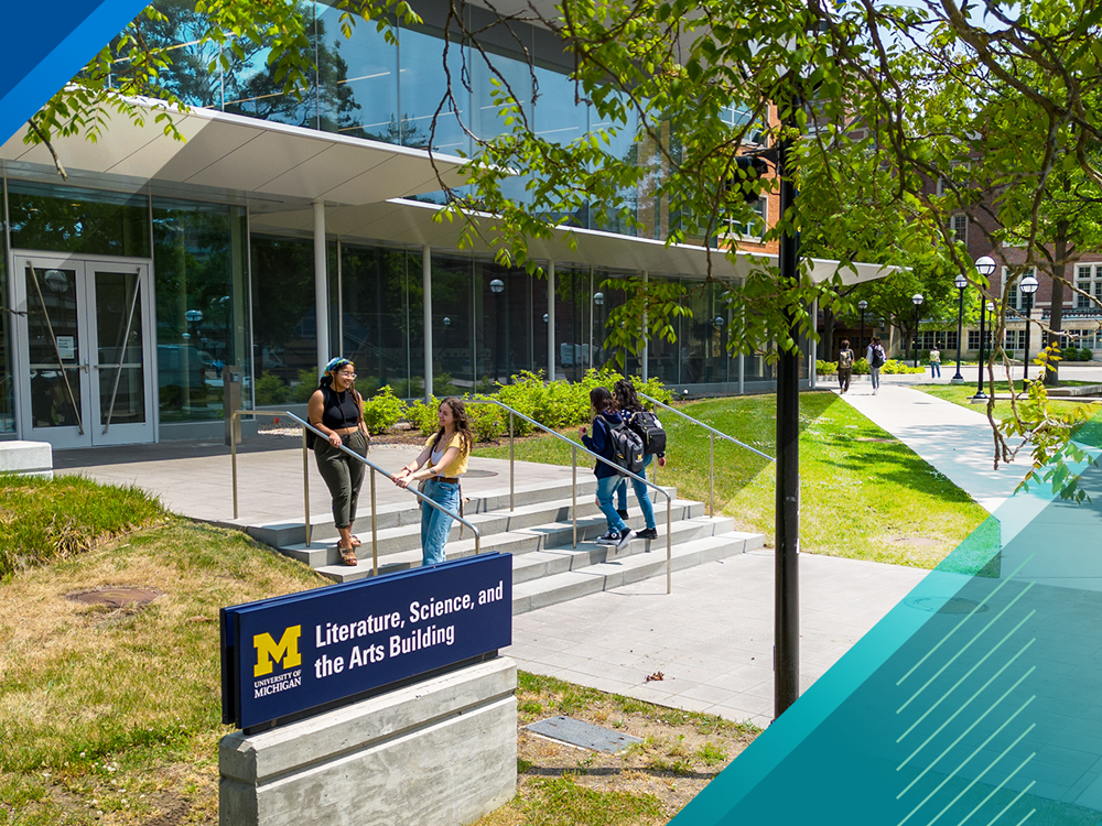 LSA building with four students standing in front.